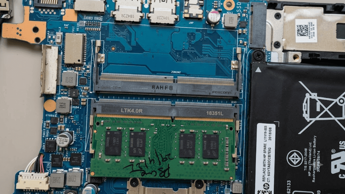 Certified engineer repairing a laptop motherboard in the Virat Systems service lab